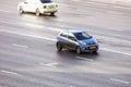 Aerial front side view rolling shot with blue car Kia Picanto in motion