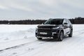 MOSCOW, RUSSIA - FEBRUARY 23, 2021 CHERYEXEED TXL SUV car in motion front side view. Black SUV on nature background Royalty Free Stock Photo