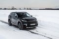 MOSCOW, RUSSIA - FEBRUARY 23, 2021 CHERYEXEED TXL SUV car in motion front side view. Black SUV on nature background Royalty Free Stock Photo