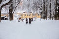 Senior women walk along a snow-covered path in the Park Royalty Free Stock Photo