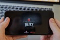 Moscow / Russia - February 20, 2019: holding an iPhone on MacBook background. World of tanks game is loading.