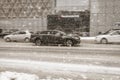 Kia Forte driving on winter city road during blizzard. Kia K3 car in motion, side view