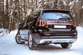 Moscow, Russia - February 15, 2021: Kia Mohave 2021 black SUV parked in the forest in winter. On the road. Alone in the woods back Royalty Free Stock Photo