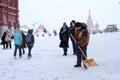 A male utility worker in Red Square shovels snow after a heavy snowfall