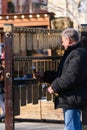 Moscow, Russia-February 2020: a man plays a Russian percussion musical instrument made of brass plates . `Bilo` - flat bells