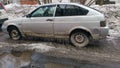 Old Vaz car parked on the street in spring, with lots of icicles.