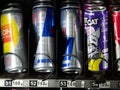 Moscow, Russia - February 8, 2020: Red Bull, E-On energy drinks in metal cans in a transparent glass window of a vending machine. Royalty Free Stock Photo