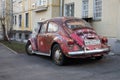Moscow, Russia, February 21, 2020: a red retro economy car-a Volkswagen Beetle-is parked in one of Moscow`s courtyards Royalty Free Stock Photo