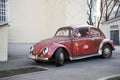 Moscow, Russia, February 21, 2020: a red retro economy car-a Volkswagen Beetle-is parked in one of Moscow`s courtyards. Side view