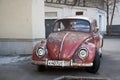 Moscow, Russia, February 21, 2020: a red retro economy car-a Volkswagen Beetle-parked in one of Moscow`s courtyards. Front view. Royalty Free Stock Photo