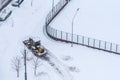 Moscow, Russia - February 14, 2021: Tractor cleans snow on the road after heavy snowfall in residential area in Moscow Royalty Free Stock Photo