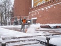 A utility worker cleans snow with a snowplow at the grave of the Unknown Soldier in the Kremlin during a snowfall Royalty Free Stock Photo