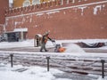 A utility worker cleans snow with a snowplow at the grave of the Unknown Soldier in the Kremlin during a snowfall Royalty Free Stock Photo