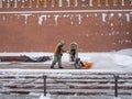 A utility worker cleans snow with a snowplow at the grave of the Unknown Soldier in the Kremlin during a snowfall Royalty Free Stock Photo