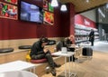 Moscow, Russia, February 2020: Workspace in Auchan supermarket: two young men work with gadgets in headphones. In the background Royalty Free Stock Photo