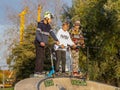 Group of teenager boys skateboarding and scooter riding in the park.