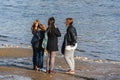 Group of young girls on background of river. People walking in the park. Royalty Free Stock Photo