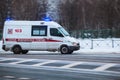 Moscow, Russia - January 14 2021: An ambulance with flashing lights on is driving along the street