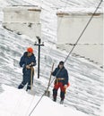 Snow removers standing on snowed rooftop Royalty Free Stock Photo