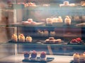 Moscow, Russia - January 17, 2020: Cakes on the shelves of a window of a street restaurant. Showcase of a pastry shop or cafe with