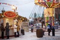 Christmas Fair Gum Fair on Red Square. People ride on a carousel in the form of a teapot and mugs. Evening, dusk