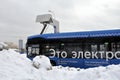 Electric bus at the charging station during recharging. Work in harsh winter conditions