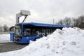 Electric bus at the charging station during recharging. Work in harsh winter conditions