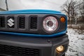 MOSCOW, RUSSIA - JANUARY 24, 2020: Headlight headlamp of new mini SUV Suzuki Jimny Static Photos in winter forest. new