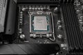 Moscow, Russia - January 12, 2022: Latest Intel i7 12700kf processor chip in socket on MSI z690 motherboard. Intel is one of