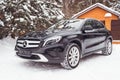 Mercedes Benz GLA 250 on a snow-covered street outside the city.