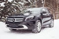Mercedes Benz GLA 250 on a snow-covered street outside the city.