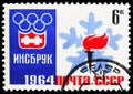 Postage stamp printed in USSR Russia shows Innsbruck Winter Olympics, 1964, Olympic Emblem and Torch, serie, circa 1964