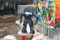A transformer robot covered with snow on a winter day