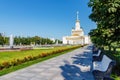 Moscow, Russia - July 22, 2019: Benches under green trees on alley in VDNH park at sunny summer morning. VDNH is popular touristic