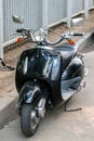 Black moped in the Parking lot. Close up.