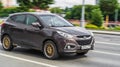 Brown Hyundai iX35 SUV car is driving on the street. Fast moving vehicle on Moscow motorway. Compliance with speed limits on the