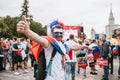 MOSCOW, RUSSIA - JULY 2018: A football fan with a face painted in colors of the Russian flag and with a headdress in the fan zone