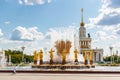 Moscow, Russia - July 22, 2019: Fountain Friendship of Peoples on a background of USSR pavilion in VDNH park in Moscow against