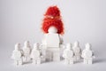 Moscow, Russia - July 26, 2022. A large white figure in the form of a lego in a New Year\'s hat among small white figures