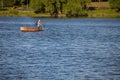 Moscow, Russia - July 21, 2022: a man on a rusty metal boat sails to the shore Royalty Free Stock Photo