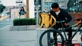 MOSCOW, RUSSIA - JULY 16, 2022. Migrant Yandex Food delivery bike courier waits for the order