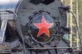 Moscow, Russia - July 28, 2019: An old black Soviet steam locomotive with a red star on the hull stands on the platform of the Royalty Free Stock Photo