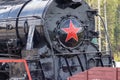 Moscow, Russia - July 28, 2019: An old black Soviet steam locomotive with a red star on the hull stands on the platform of the Royalty Free Stock Photo