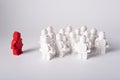 Moscow, Russia - July 26, 2022. A red lego figure stands in front of a group of white figures