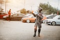 Moscow, Russia - July 06, 2019: special forces soldier guards cars. Cosplay anime fighter with fake weapons and a water pistol.