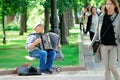 A street musician plays a accordion in the Moscow park.