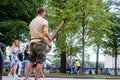 A musician plays an ethnic African instrument in a summer park