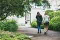 Moscow, Russia - JULY 7, 2017: Two young women walk through the streets of the city. They are going in the direction of