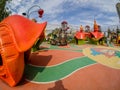 Unidentified people look at playground equipment in children amusement park