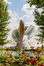 Moscow, Russia - July 22, 2019: View of Golden Spike fountain on Kamensky pond in VDNH park in Moscow against green trees and